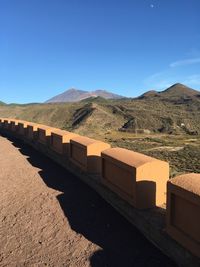 View of mountain range against blue sky