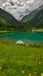 Scenic view of lake and mountains against sky