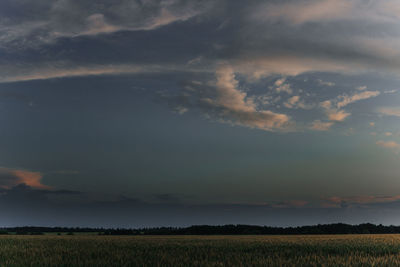 Scenic view of field against sky at sunset