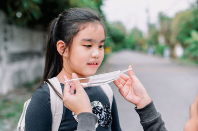 Portrait of cute girl holding camera