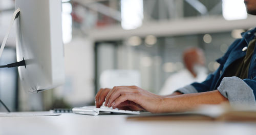 Midsection of woman using mobile phone in office