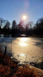 Scenic view of lake against sky during winter