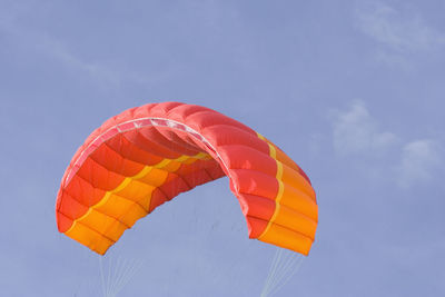 Low angle view of parachute against sky