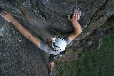 High angle view of male hiker rock climbing