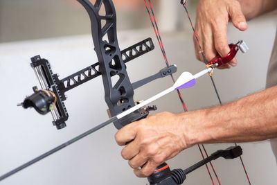 Close-up of man holding bow