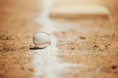 Close-up of baseball on sand