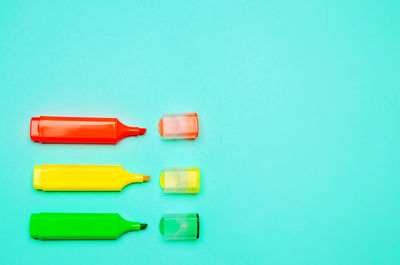 Minimalism. three multicolored markers on a blue background. creativity, pin up, school stationery