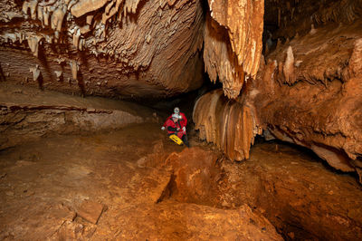 High angle view of man sitting on rock