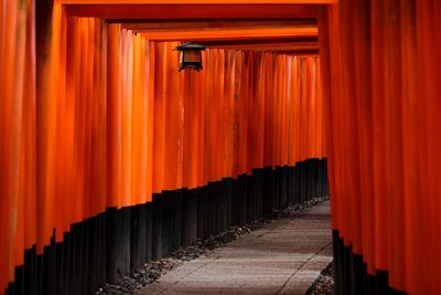 Corridor of building against orange sky