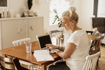 Woman using laptop at home