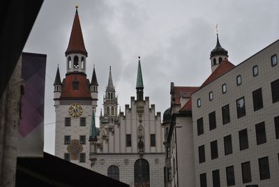 Low angle view of church and buildings against sky in town