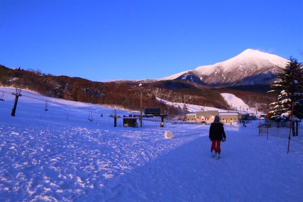 REAR VIEW OF SNOW COVERED LANDSCAPE AGAINST MOUNTAIN