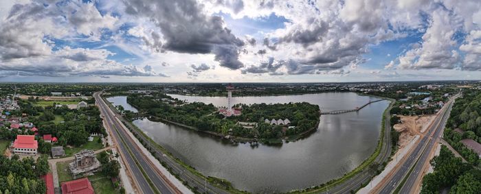 High angle view of river amidst city against sky