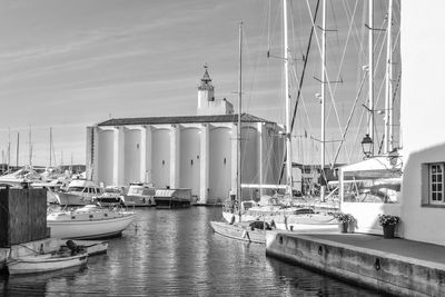 Boats moored on shore against sky