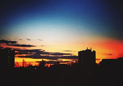 Silhouette of built structures at sunset