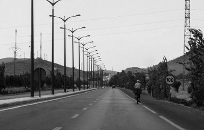 Road by building against sky