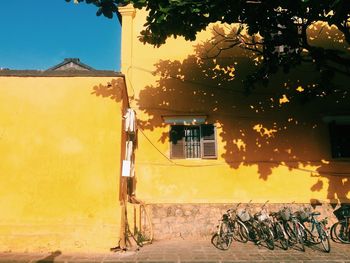 Bicycle against yellow building