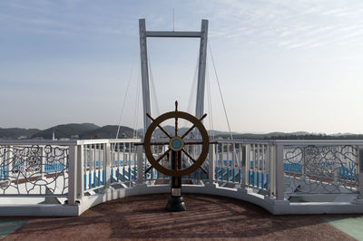 Steering wheel on bridge against sky