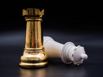 Close-up of bottles on table against black background