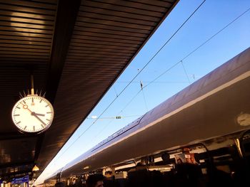 Low angle view of clock against sky