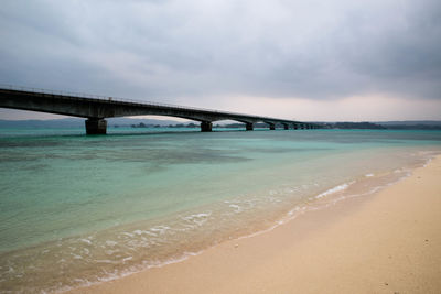 Bridge over sea against sky