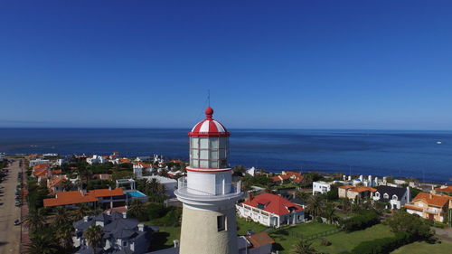 High angle view of buildings by sea against clear sky