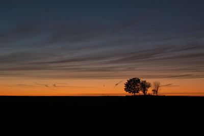 Silhouette landscape against sky during sunset