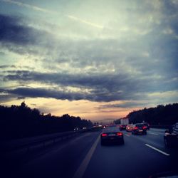 Road against cloudy sky at sunset