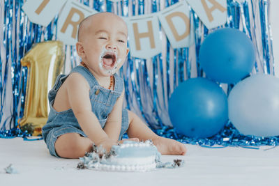 Portrait of cute girl playing with balloons