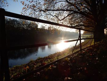 Scenic view of river against clear sky at sunset