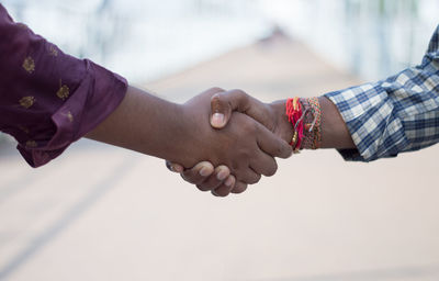 Cropped image of couple holding hands