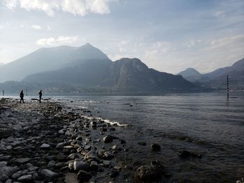 Scenic view of sea and mountains against sky