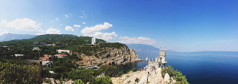 High angle view of sea and mountains against sky