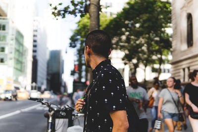 Rear view of man standing on road