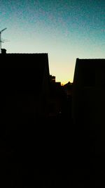 Buildings against clear sky at sunset