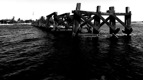 Bridge over sea against clear sky