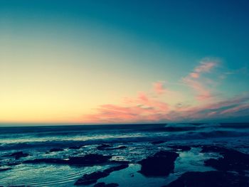 Scenic view of sea against clear sky at sunset