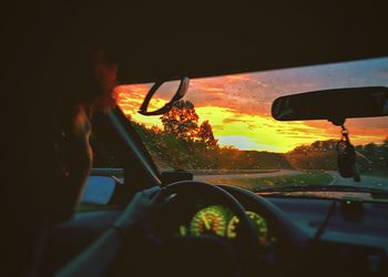 Man seen through car windshield