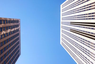 Low angle view of modern building against blue sky