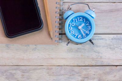 High angle view of clock on table