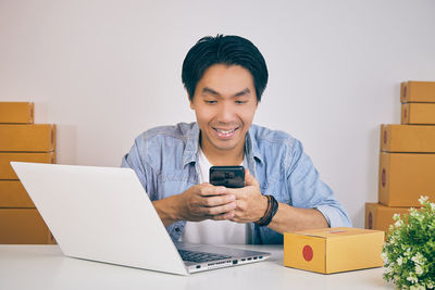 Portrait of smiling young woman using smart phone