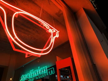 Low angle view of illuminated neon sign at night