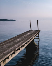 Pier over lake against sky