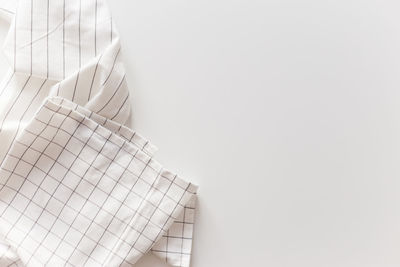 High angle view of white paper against wall