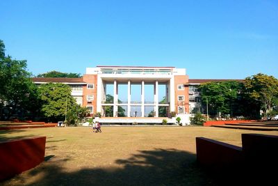 Buildings against clear blue sky