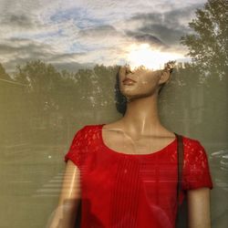 Close-up of woman sitting on wall