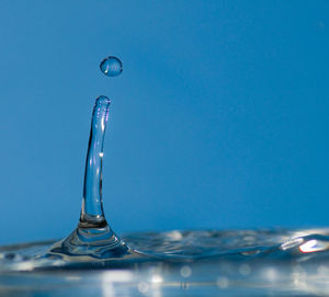 Close-up of water splashing against blue background