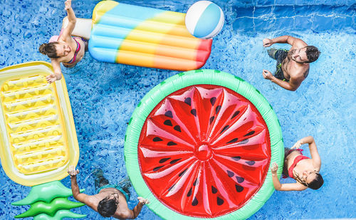 High angle view of people playing with ball in swimming pool