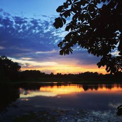 Scenic shot of calm lake at sunset