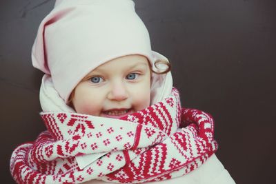 Portrait of cute girl in warm clothing at home